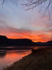 Sunset over a lake in Minnesota with bluffs behind