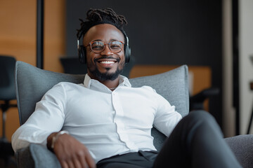 Man enjoying music while relaxing in modern chair