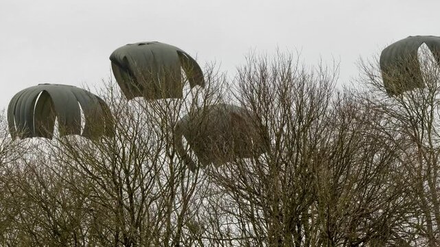 large CDS container floats to ground under massive parachutes from an Airbus A400M drop