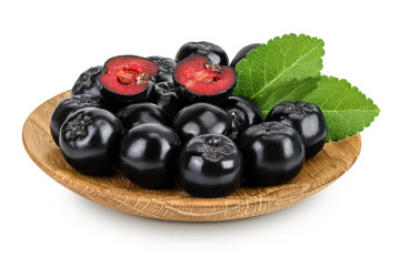 Chokeberry in wooden bowl isolated on white background. Black aronia.