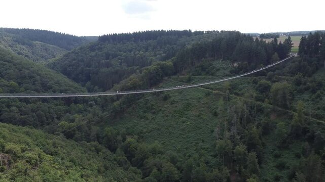 M&ouml;rsdorf, Germany - August 19th 2024: Drone flying away from the Geierlay Suspension Bridge.