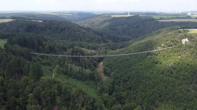 M&ouml;rsdorf, Germany - August 19th 2024: Drone flying over the Geierlay Suspension Bridge at hight.