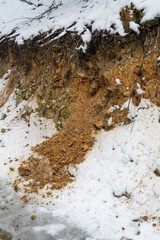 Spilled dirt on a slope with snow.
