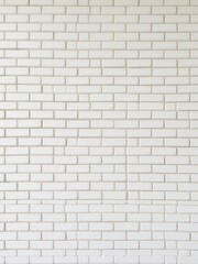 Fototapeta premium Vertical rows of white ceramic brick tiles creating a sleek and modern wall design, home, interior