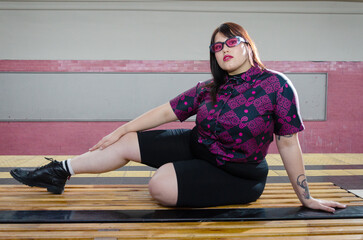 Beauty Brunette Plump Girl With A Purple Shirt Posing In A Train Station