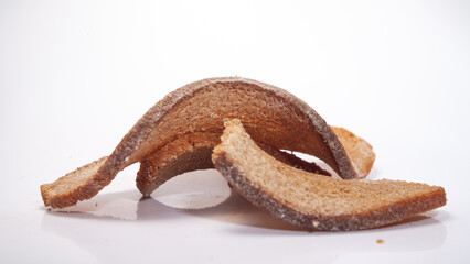 Unique arrangement of crispy bread pieces on a plain background showcasing texture and color