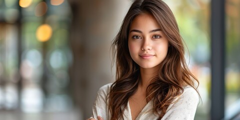 Obraz premium Portrait of a Young Woman with Long Hair Smiling Softly While Standing in a Brightly Lit Room with Blurred Background and Circular Lights