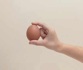 Mocha Mousse egg. A child's hand holds a chicken egg. A child's palm holds a chicken egg.
The color of the year is Pantone 2025. Minimalistic design with "Mocha Mousse"