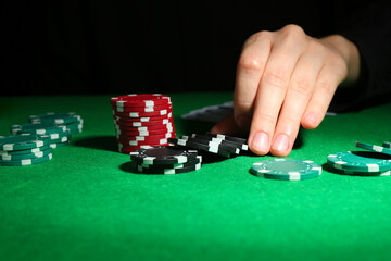 Woman with poker chips at green table, closeup