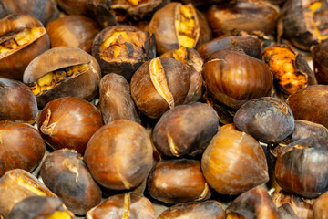 Close-up with out of focus background of typical Christmas roasted chestnuts.