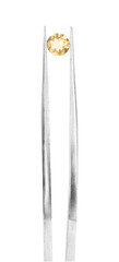 Tweezers with shiny yellow gemstone isolated on white