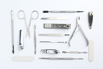 Set of pedicure tools on light background, flat lay