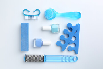Set of pedicure tools on light background, flat lay