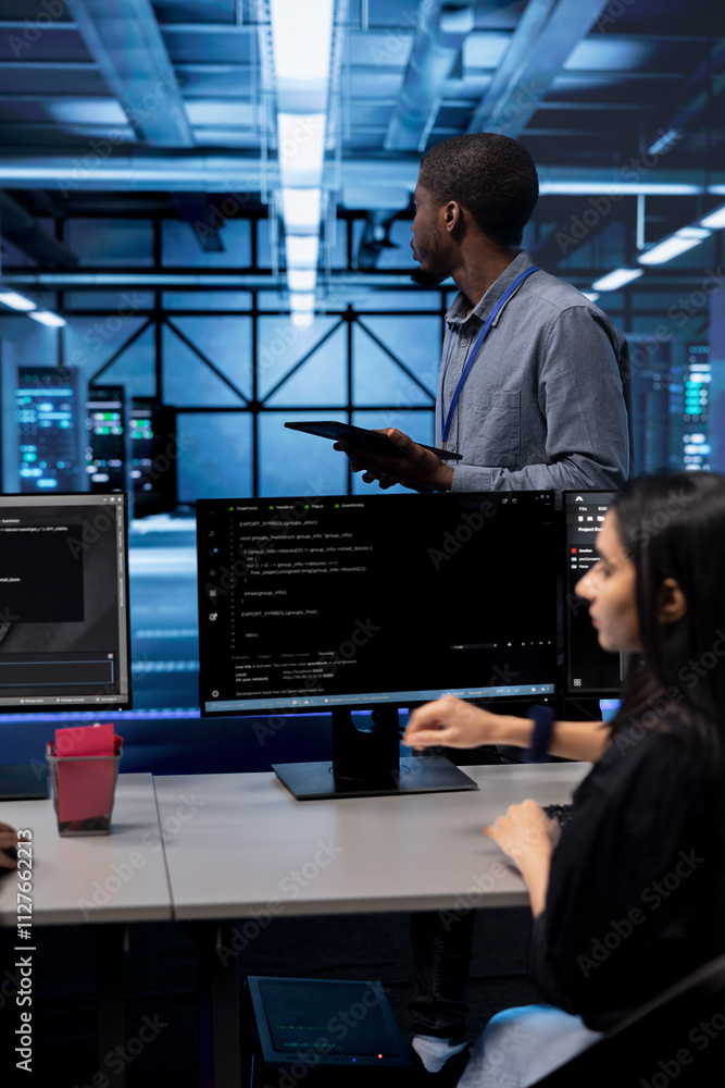 Poster engineer in data center updating systems to keeps performance up and protect servers from easily exp