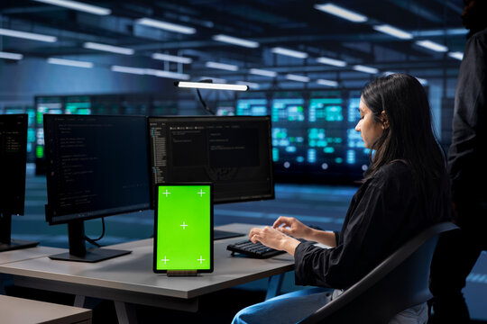 Admin in server hub uses isolated screen device to find firewall misconfigurations affecting performance. Woman checking systems bottlenecks leading to sluggish data transfer rates using mockup tablet - Powered by Adobe