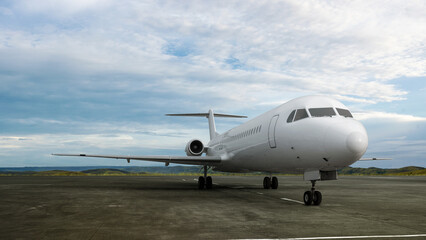 Commercial airplane on the runway with a blue sky background