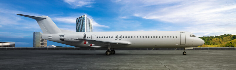 Commercial airplane on the runway with a blue sky background