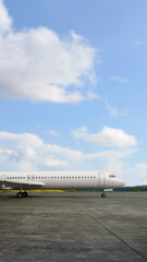 Commercial airplane on the runway with a blue sky background