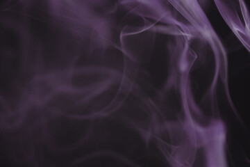 Close up of incense smoke as background. Smoke is the gaseous products of burning materials especially of organic origin made visible by the presence of small particles of carbon