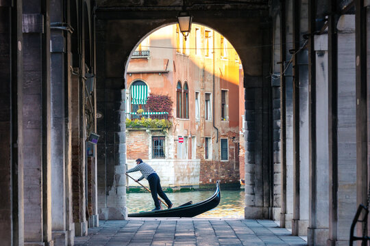 Gondola on the Grand canal seen through arch, Venice, Italy