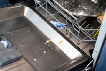 The dishwasher is loaded with dishes, a shot with a detergent tablet.