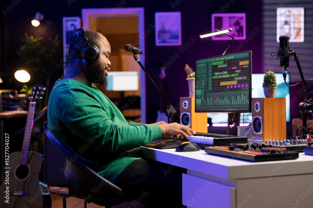 Aufkleber Sound designer playing piano and recording audio files on DAW software, producing new tracks and adding effects in post production. Artist musician creating songs for music industry.