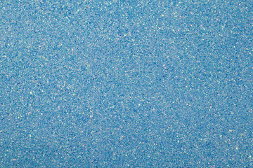 Blue paper with glitter and sprinkles. Rough texture effect with sparkles. Photography made
