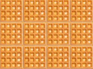Uniform arrangement of square waffles with golden-brown tones, creating a seamless pattern. Perfect for food-related designs, backgrounds, or culinary presentations emphasizing texture and symmetry.
