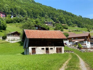 Traditional rural architecture and family livestock farms on the shores of Lake Lungern - Canton of...