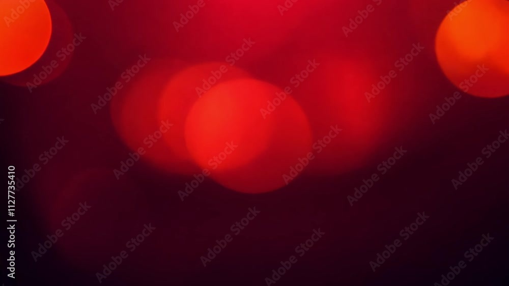 Poster this video features a deep red background with subtle shimmering and large oval bokeh lights