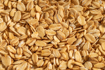 Close-up of rolled oats texture. Perfect for backgrounds and natural food themes.