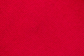 Diagonal texture of red knitted sweater. Selective focus, copy space