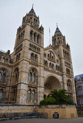 London, England, United Kingdom - October 2024: Exterior of Natural History Museum in London with blue sky and clouds autumn or fall