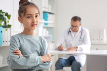 Fototapeta premium Little girl smiling at pediatrician's office, closeup