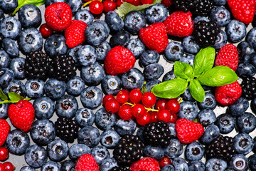 Mix of different berry berries. Berries fruits background. Antioxidants, detox diet, organic berries. Wild berries pattern. Berry background.