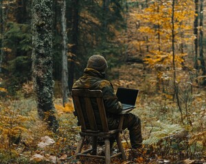 Fototapeta premium Man Working on Laptop in Autumn Forest