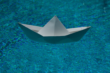 Paper ship in water. Tourism and traveling. Paper boat in water. Paper boat sailing. Vacation...
