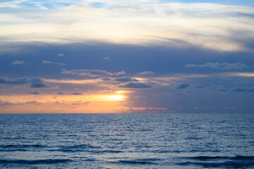 Obraz premium Scenic coast view. Ocean waves background. Sunrise on the sea with clouds background.