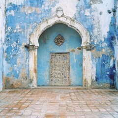Naklejka premium Ancient Blue Wall with Ornate Archway and Door
