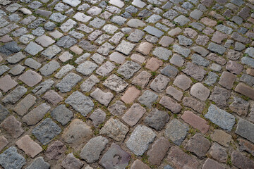 Stone road pattern background. Cobblestone pavement background. Textured background of cobblestone road. Brick road background.