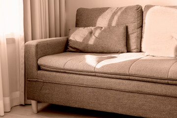 Sofa next to curtains close-up in trending color of year 2025.