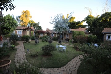 Fototapeta premium Charming Garden Pathway Leading to Cozy Cottage, Madagascar