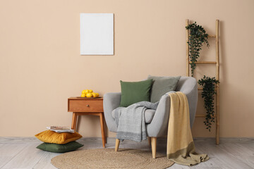 Interior of living room with armchair, ladder and lemons on table