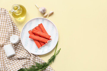 Plate with tasty crab sticks, garlic and dill on yellow background © Pixel-Shot