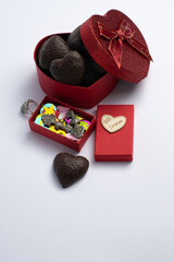 Valentine's Day box with heart-shaped chocolates; box with keys and confetti located at the top of the vertical plane.