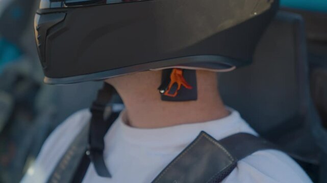 Man buckling helmet in offroad vehicle