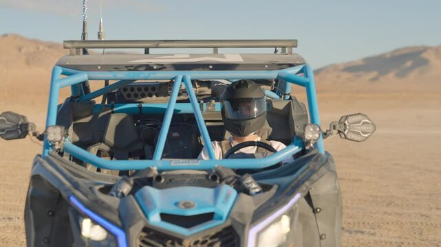 Driver in an offroad UTV vehicle wearing a helmet