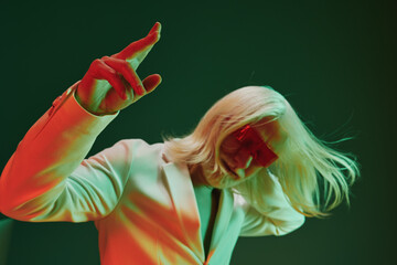 Stylish person in a surreal pose with smoking cigarette, wearing a white suit against a colorful...