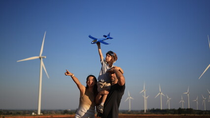 A young boy, surrounded by his family, discovers the wonders of green renewable energy at a vibrant...