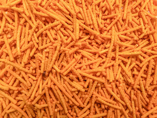 Heap of corn sticks, crispy snacks food.